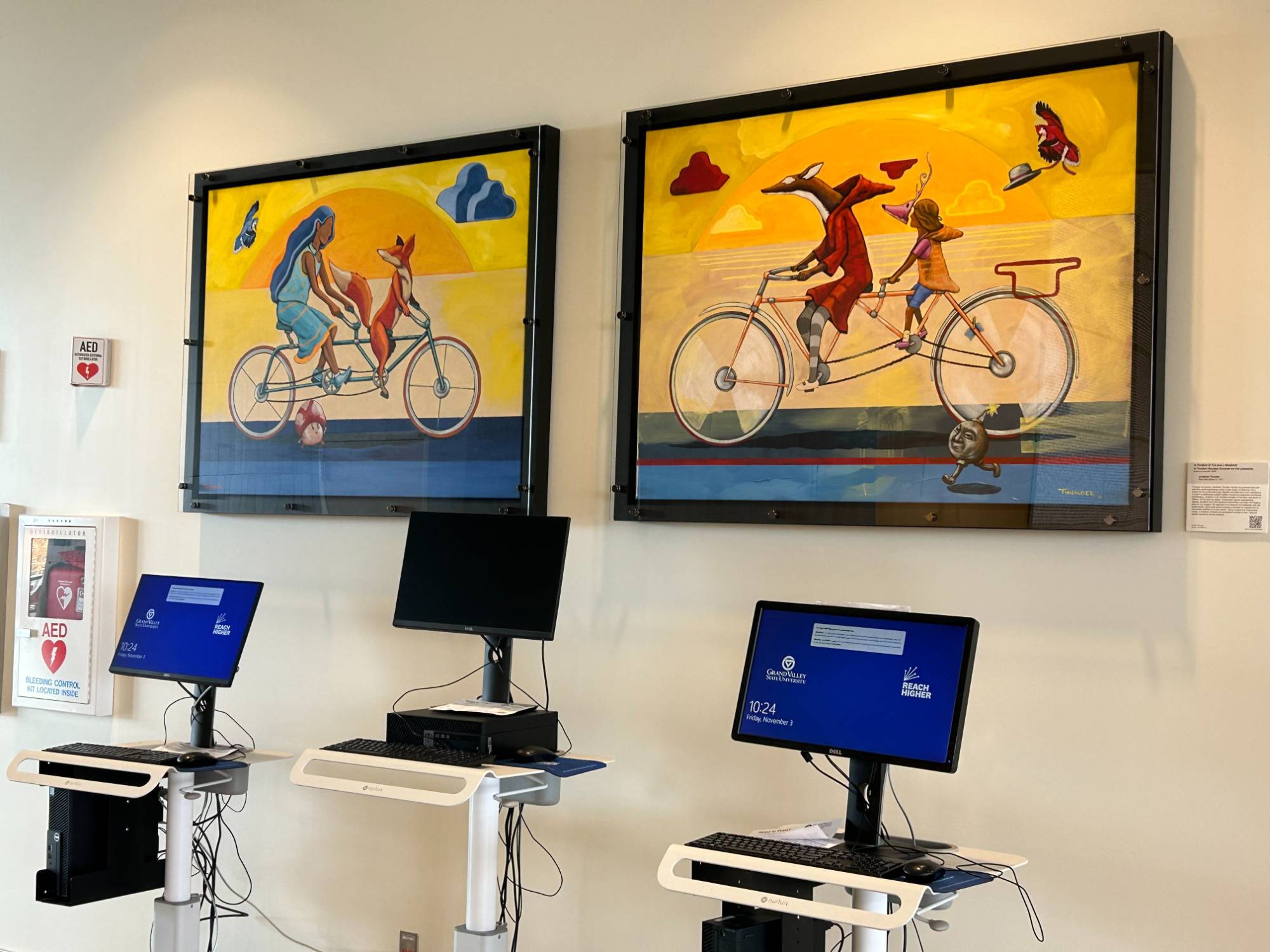 Artwork displayed above computers inside the Mary Idema Pew Library.